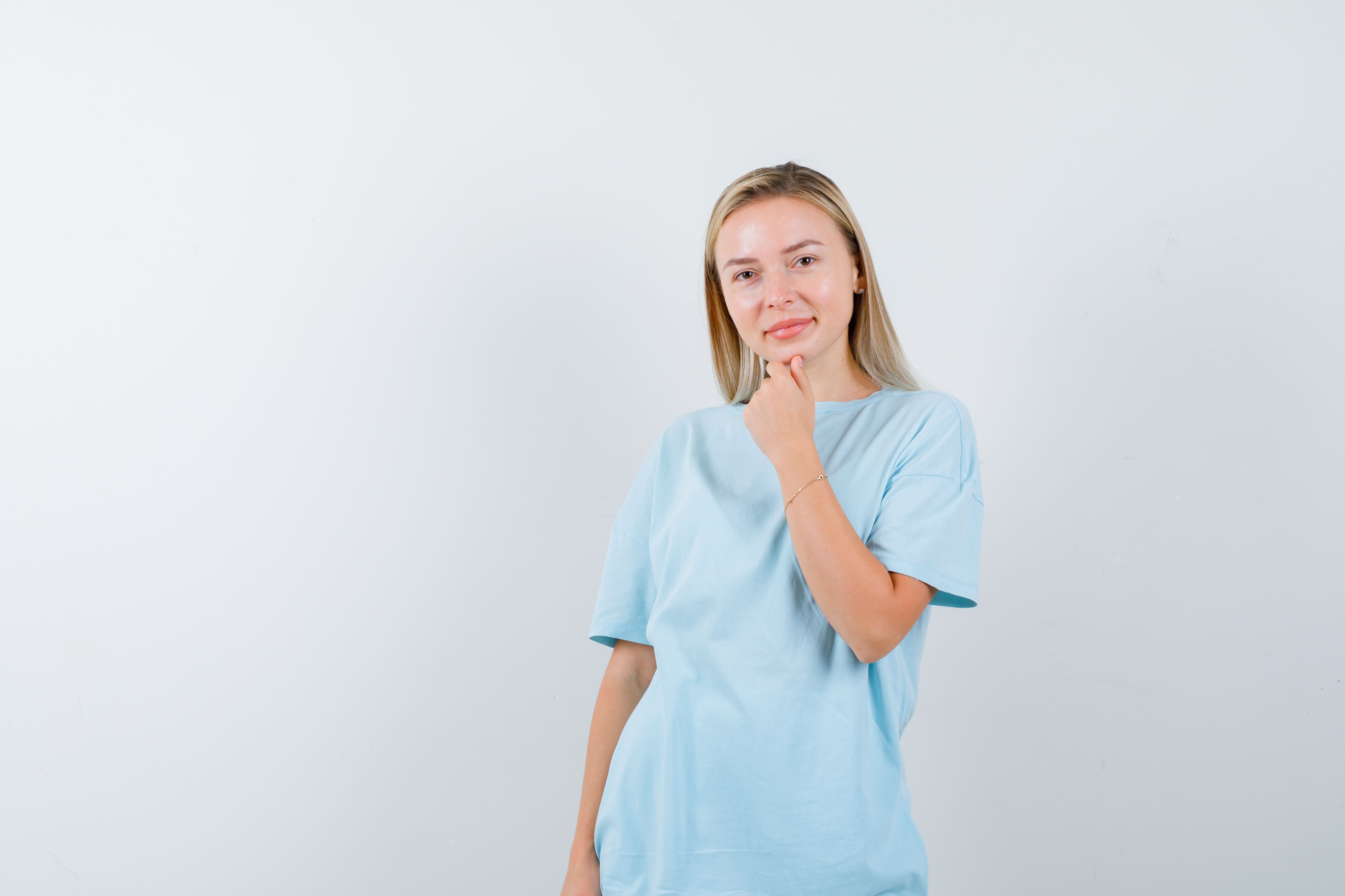 blonde-woman-propping-chin-fist-blue-t-shirt-looking-happy.jpg
