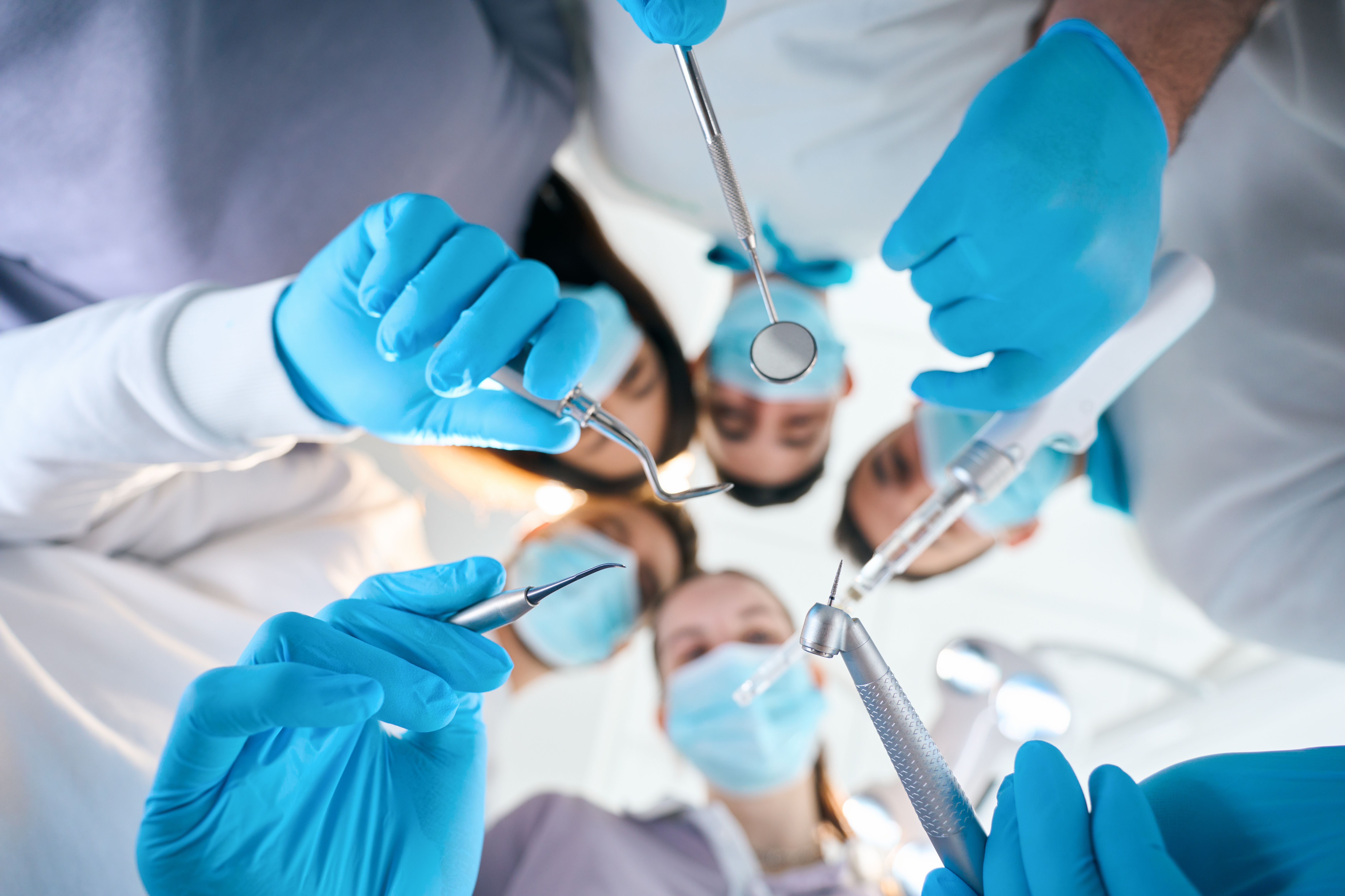 five_dentists_with_special_tools_in_their_hands